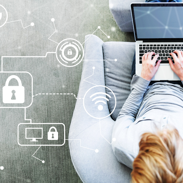 Cyber Security with man using a laptop in a modern gray chair